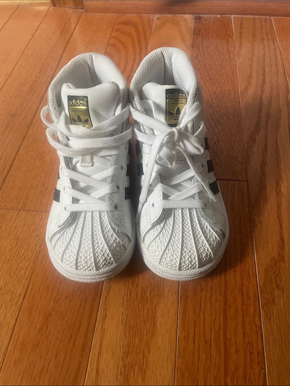 adidas Kids White Sneakers with Black Stripes and Gold Tongue Label